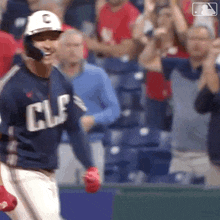 a baseball player wearing a helmet and a jersey with the letter c on it