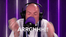 a bald man wearing headphones and a purple hat says arrghhh