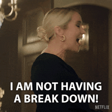 a woman in a black dress says i am not having a break down
