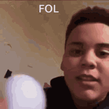 a close up of a man 's face with the word fol written on the bottom