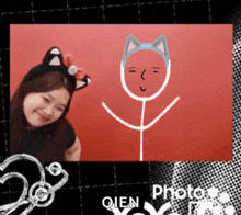 a picture of a girl with a cat ear headband and a stick figure with a cat face drawn on it