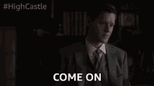 a man in a suit is saying come on