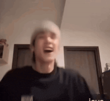 a blurry picture of a man wearing a beanie and a black shirt that says nirvana