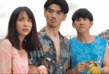 a group of people are standing next to each other and one of them is holding a baby