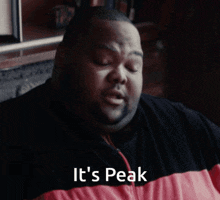 a man says it 's peak in a red and black jacket