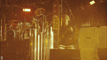 a person playing a guitar in front of an amplifier that says ' fender ' on it