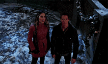 a man and a woman are standing in the snow with mistletoe written on the bottom