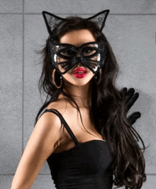 a woman wearing a cat mask and cat ears on her head