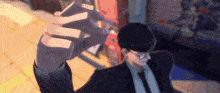 a man in a suit and tie is holding something in his hands .