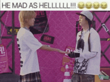 a man in a white shirt is shaking hands with another man