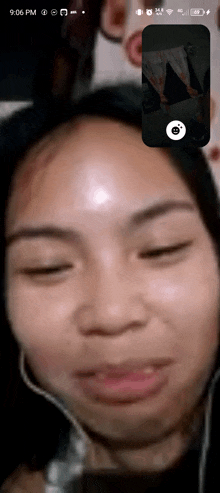 a woman 's face is shown on a phone screen with the time 9:06 pm