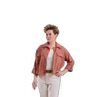 a woman wearing a pink jacket and white pants is raising her hand in the air