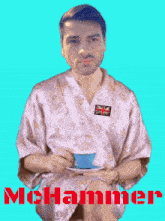 a man in a robe is holding a cup and saucer and the name mohammer is on the bottom right