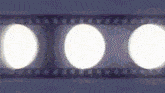 three white circles are on a blue background