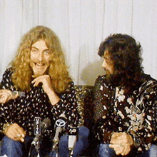 two men are sitting in front of microphones and one of them is wearing a shirt that says toyota