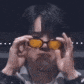 a man is wearing sunglasses and making a face .