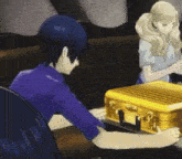 a man and a woman are sitting at a table with a yellow briefcase
