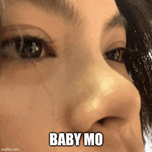 a close up of a woman 's nose with the words baby mo written on it