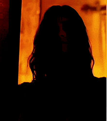 a close up of a woman 's face with a skeleton around her neck
