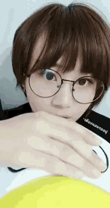 a woman wearing glasses and a black shirt that says ' ' ' ' ' ' on it