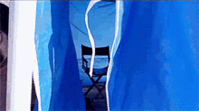 a blue tent with a director 's chair inside of it