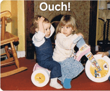 a boy and a girl are riding a tricycle with the words ouch above them