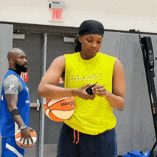a woman wearing a yellow shirt that says dallas basketball