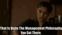 a woman in a black shirt with the words that is quite the management philosophy you got there below her