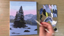 a person is painting a snowy landscape with a palette in the background