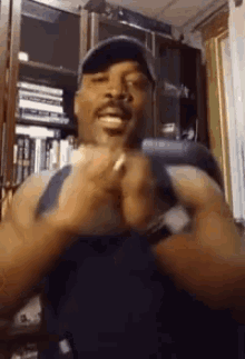 a man in a hat is holding a cell phone in his hands