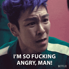 a man with purple hair says i 'm so fucking angry man !