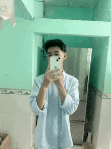 a man taking a picture of himself in a mirror with an apple phone