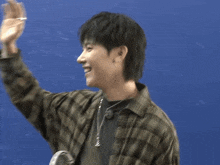 two young men giving each other a high five in front of a blue background