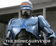 a robot is standing in front of a building with the words `` the bionic surveyor '' written on the bottom .