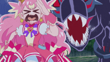 a girl in a pink dress with a heart shaped bow is standing next to a monster with sharp teeth
