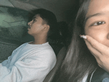 a man and a woman are sitting in a car