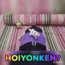 a stuffed animal laying on a bed with the words hoiyonken