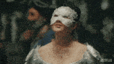 a woman wearing a white lace mask with a netflix logo on the bottom right