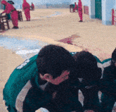 a group of people are playing a game and one of them is wearing a green jacket with the number 006 on it