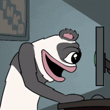 a panda bear is looking at a computer screen