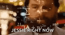 a man with a beard is wearing headphones and looking at a screen with mathematical equations .