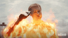 a poster for fantastic four shows a man covered in flames