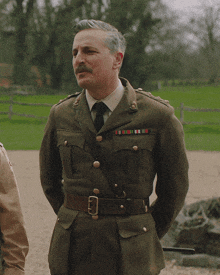 a man in a military uniform has a belt around his waist