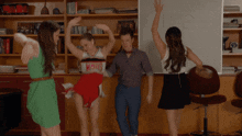 a group of cheerleaders are dancing in front of a white board with the number 10 written on it