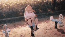 a girl with horns sits on a seesaw in a playground