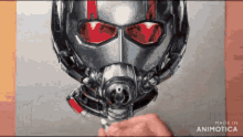 a drawing of an ant man 's helmet with red eyes