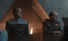 two men are sitting at a table with the words deep substrate foliated behind them