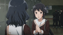 a girl with the number 26 on her back is talking to another girl
