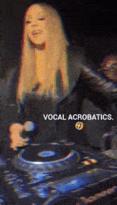 a woman singing into a microphone with the words vocal acrobatics above her