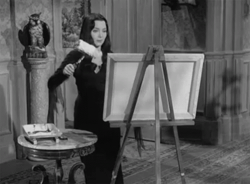 Wednesday Adams using a paint roller on a canvas